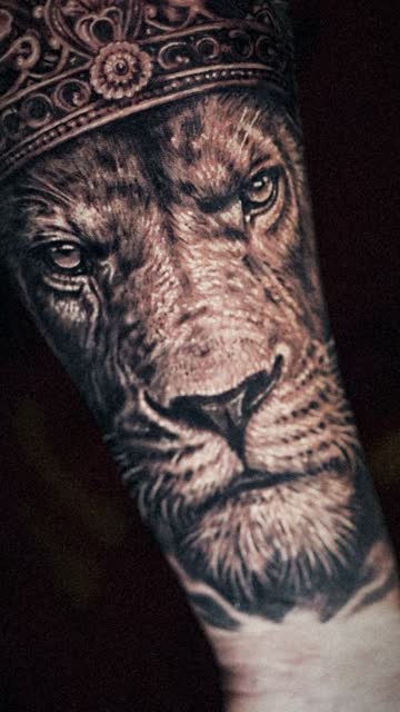 Slow-motion frame of a finished realism lion tattoo